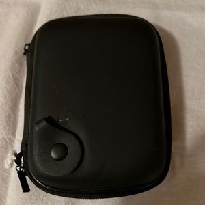 Small, hard shell travel case 6”w x 4.5”h.